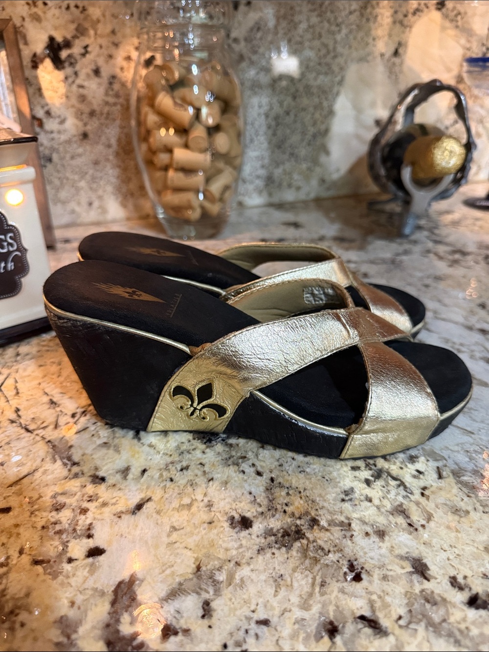 Volatile Gold Crisscross Wedge Slides with Fleur-de-Lis Accent